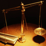 photo of balance scale with money on one side and contract on the other