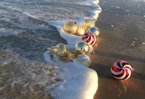 Christmas ornaments in the surf on the beach - naplesbonitamarco.com
